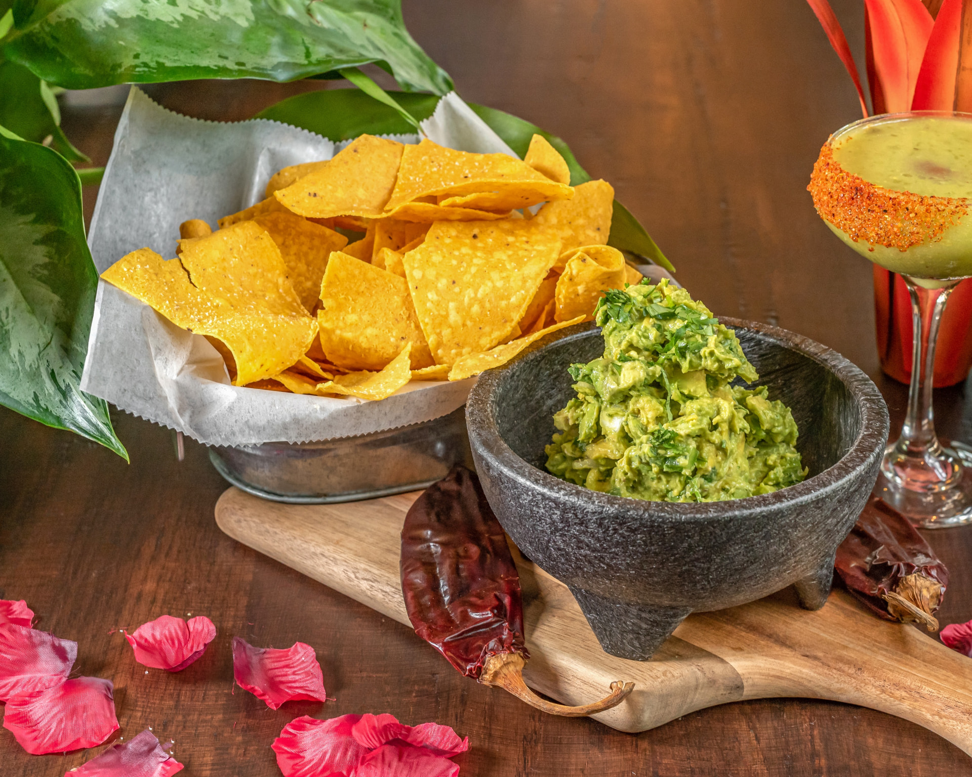 El Camino guacamole served in a stone molcajete with tortilla chips and a margarita